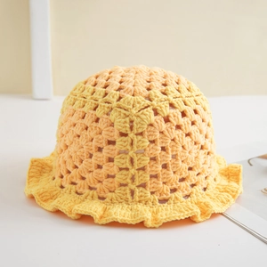 Detail showing hand-crocheted hollow texture and ruffled brim of a yellow knit bucket hat