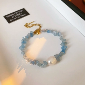 Detail of 925 silver clasp on aquamarine stone and pearl bracelet in a gift box