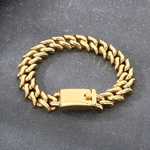 Detailed close-up of 15mm thick gold stainless steel Cuban chain link bracelet with clasp