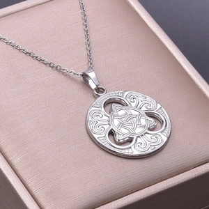 Macro shot of silver stainless steel Triquetra pendant in a pink silk jewelry box