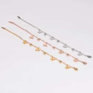 Three-color butterfly charm bracelets in gold, silver, and rose gold with polished beads