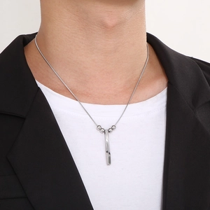 Mens minimalist silver spiral bar pendant necklace on a snake chain shown on a model