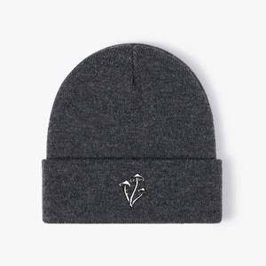 Detailed view of dark grey beanie with white three-mushroom embroidery on the cuff