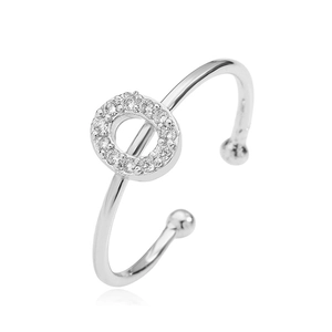 Detailed view of silver open ring with round diamond-encrusted top and bead end