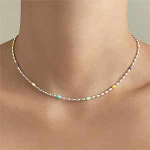 Detail of 925 sterling silver rainbow bead necklace with colorful enamel on female neck
