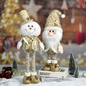 Close-up of champagne gold snowman and gnome plush dolls with sparkling sequins