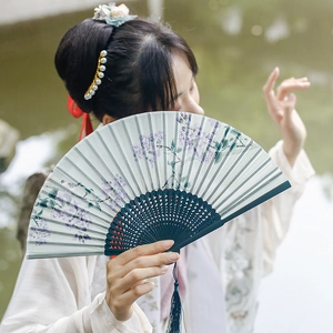 New Chinese style green folding fan with purple flower pattern and tassel detail