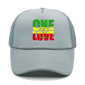 Close-up of One Love print on gray mesh trucker hat with reggae colors and fist graphic