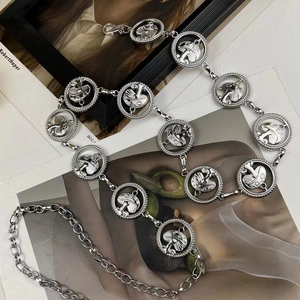 Detail of silver mushroom link metal waist chain belt over a fashion magazine