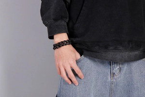Man wearing a black matte chunky skull chain bracelet with a street style aesthetic