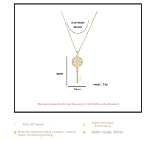 Detail view of gold key pendant necklace with size dimensions and zircon inlay specs