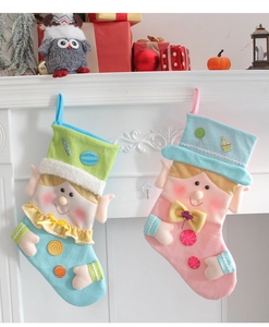 Close-up of colorful felt Christmas stockings featuring cartoon elf faces for holiday decor
