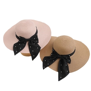 Women's wide brim straw sun hats in pink and brown with black bows and pearls decoration