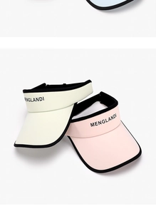 Close-up of beige and pink sun visors featuring black trim and decorative text
