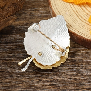 Detailed back view of a leaf-shaped silver brooch showing the secure pin closure mechanism