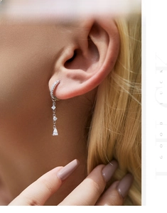 Detail of s925 silver long tassel earrings with drop-shaped cubic zirconia stones