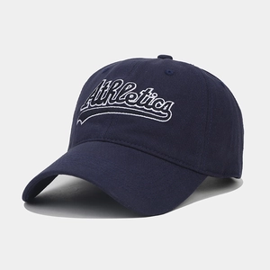 Detail of white Athletics 3D embroidery on navy blue cotton twill baseball cap