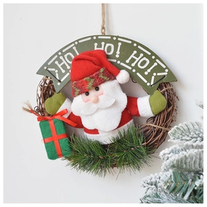 Close-up of Santa Claus plush on Christmas wreath with HO HO HO banner and pine needles