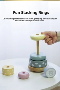 Detail of colorful wooden stacking rings with lion and cloud patterns for toddler's motor skills