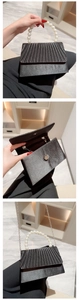 Black satin evening bag set with pearl handle, internal view, and silver chain strap
