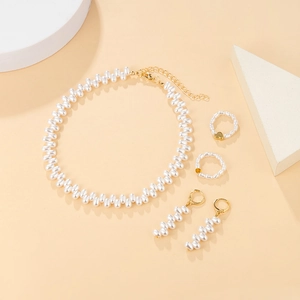 Detailed overhead view of champagne gold jewelry set with irregular rice pearls