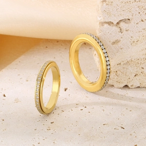 Luxe wide and thin gold stainless steel rings with full crystal pavé on travertine stone