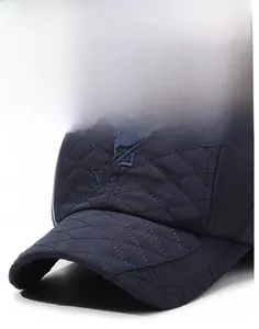 Detail of navy blue baseball cap featuring quilted diamond texture and Narason embroidery