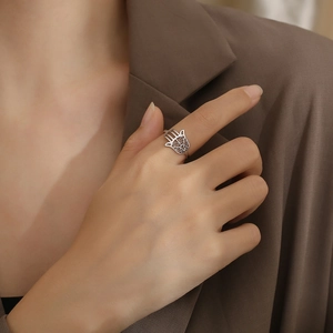 Silver Hamsa Hand openwork ring in stainless steel worn by a model in casual style