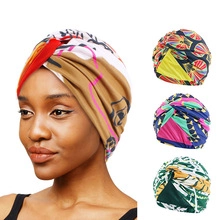 Detail view of ethnic floral turban hats for women in various colorful geometric patterns