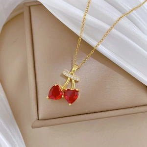 Elegant gold-plated titanium steel necklace with red crystal cherry pendant on silk