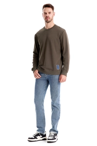 Detail of dark olive green crewneck sweatshirt with ribbed hem and blue hem label