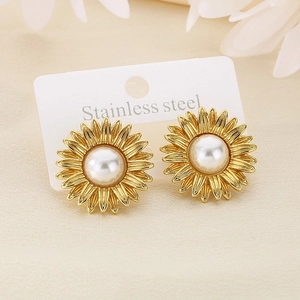 Close-up of golden sunflower pearl stud earrings on stainless steel backing card