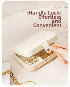 Detail of cream PU leather jewelry box featuring a convenient lock clasp and ring slots