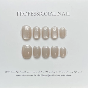 Short round nude pink champagne cat eye press-on nails with iridescent aurora glitter