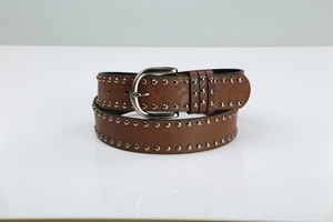 Close-up of brown leather belt featuring silver metal rivets and a classic pin buckle