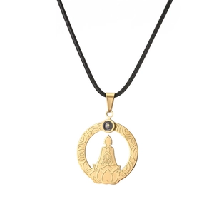 Close-up of golden Buddha circle pendant with intricate clouds and projection stone