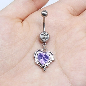 Detailed view of silver navel ring with a round clear gem and purple heart-shaped stone