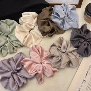 Oversized satin hair scrunchies set in pastel colors for elegant ballet style hairstyles