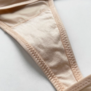 Micro shot of reinforced crotch lining and stitching on basic nude ice silk thong