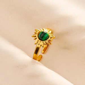 Detailed shot of golden sun-shaped ring with green malachite gemstone and adjustable band