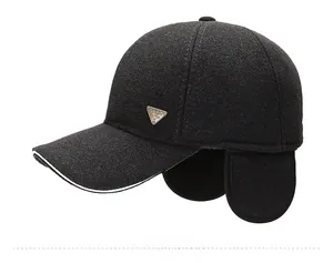Detail view of winter baseball cap with earflaps, thick thermal fabric and metal logo
