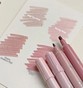 Detail view of double-ended highlighters with dual tips and color swatches in soft tones