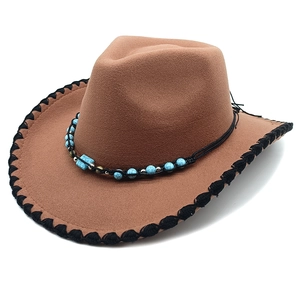Detail of brown wool felt cowboy hat with turquoise bead band and black stitched brim