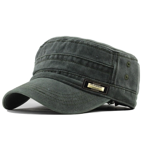 Detail of olive green flat top army cap featuring metal brand plate and washed cotton texture