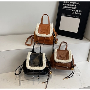 Detailed view of winter plush patchwork backpacks in black, caramel, and dark brown colors
