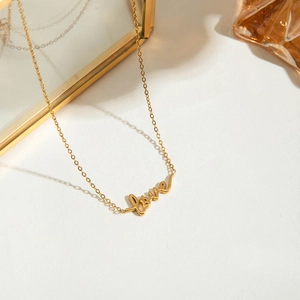Detailed view of an 18K gold-plated stainless steel necklace with a Love pendant design