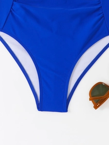 Close-up of bright blue swimsuit bottom with white lining and high-quality flat stitching