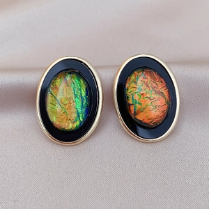 Retro geometric oval resin earrings with gold trim and iridescent center on silk