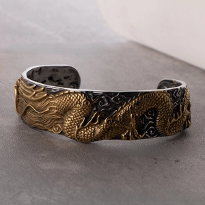 Detailed close-up of retro titanium steel bracelet with gold dragon scale relief design