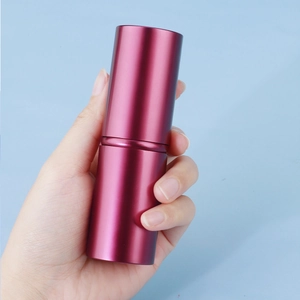 Portable burgundy retractable makeup brush with a sleek matte metal casing for travel